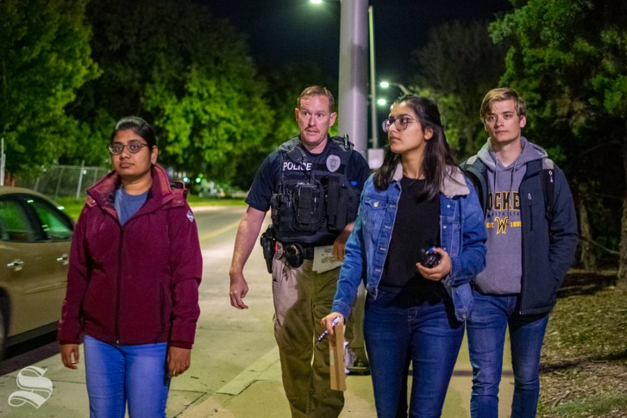A group of students participate in the Safety Walk with Officer Wyatt Pulver on Oct. 8 at the Food Truck Plaza on Wichita State's main campus. The group was given a section of Wichita State's main campus to walk and discuss safety concerns which may require improvement.