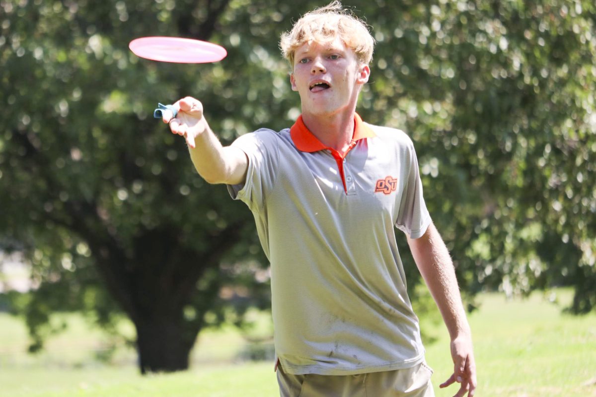 Joey Wise throws a disc at Disc Golf Club tryouts on Aug. 31 at L.W. Clapp Park. The club had a large turnout for tryouts.