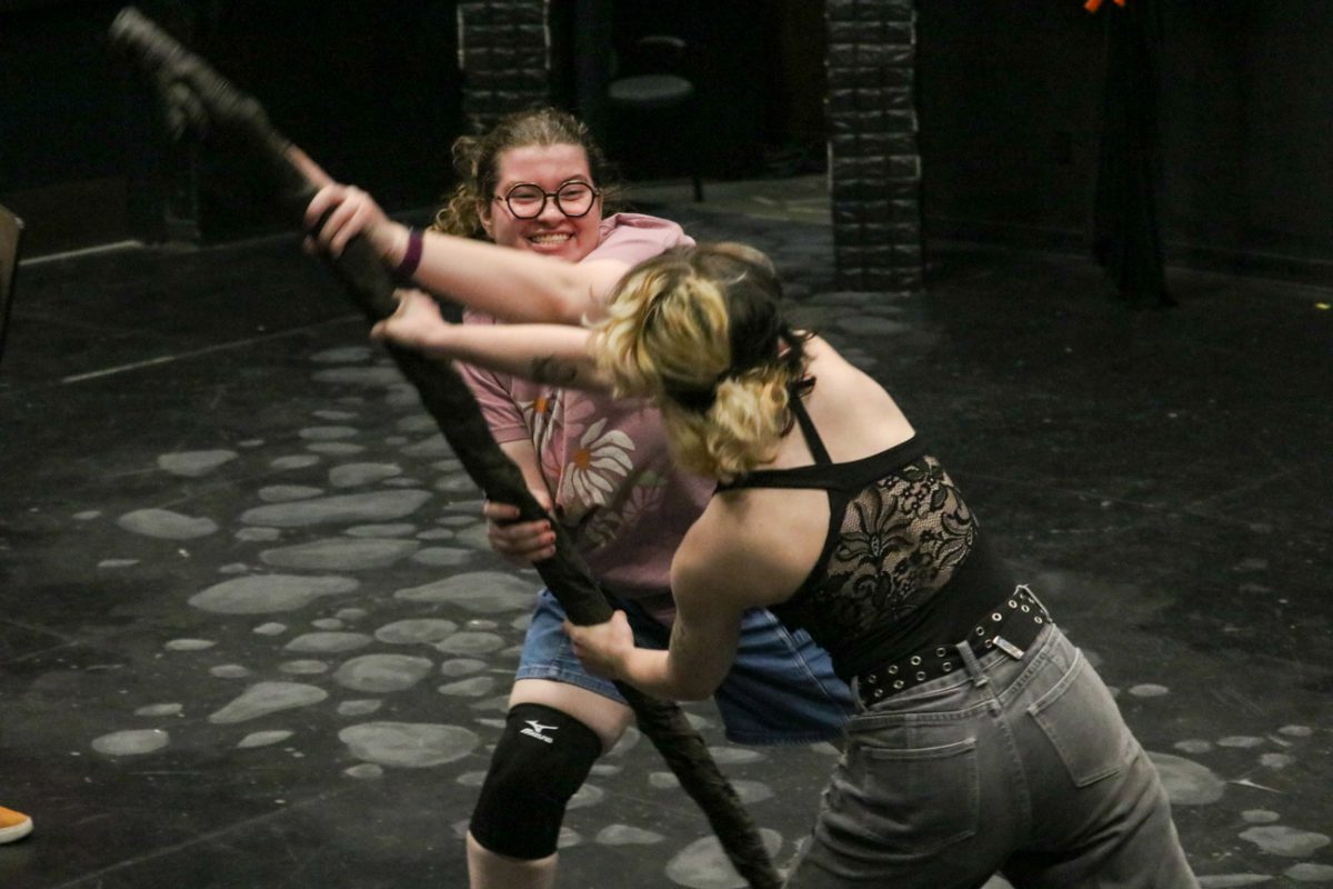 Mia Dennett and AJ Corbett practice a fight scene for "She Kills Monsters." The show opens May 1 and runs until May 3.