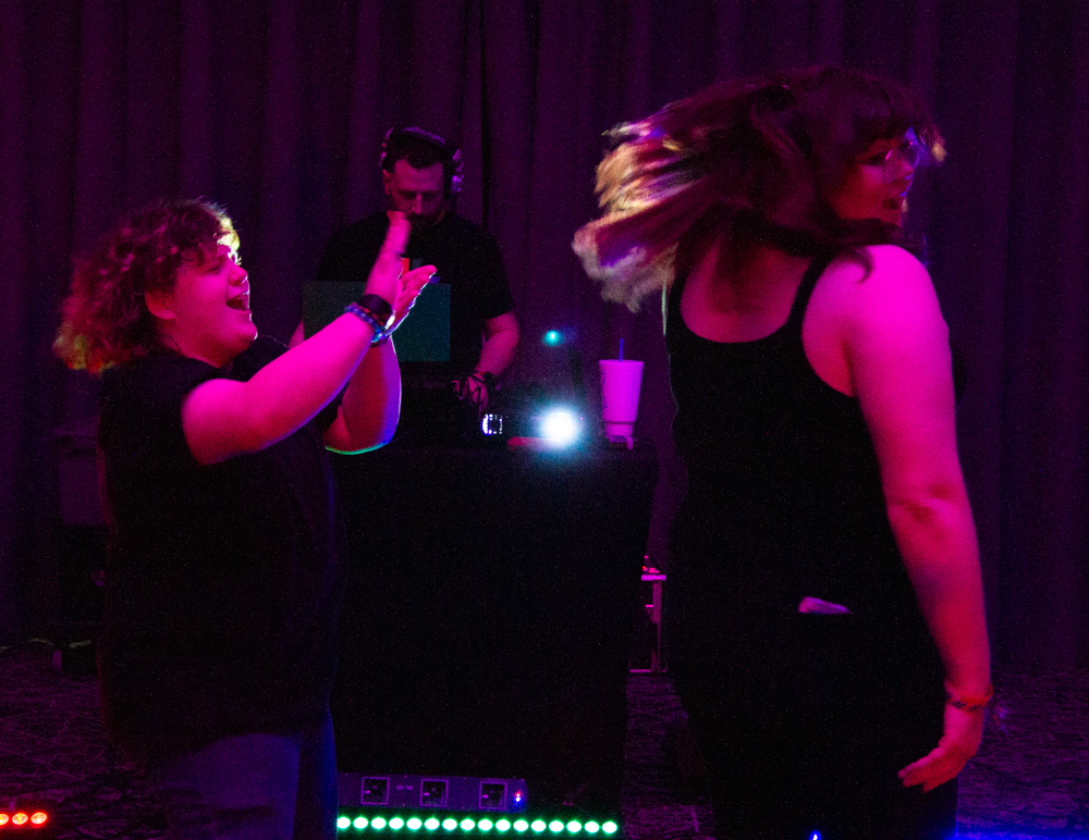 Vincent Farwell flashes pretend money towards Mik Lathe during "No Hands" by Waka Flocka. Farwell and Lathe attended the Pride Prom hosted by Spectrum on April 12.