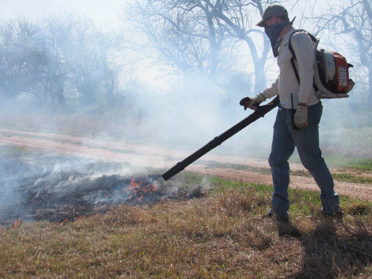 Graduate Student Parker Binns acts as a blower at the prescribed fire.